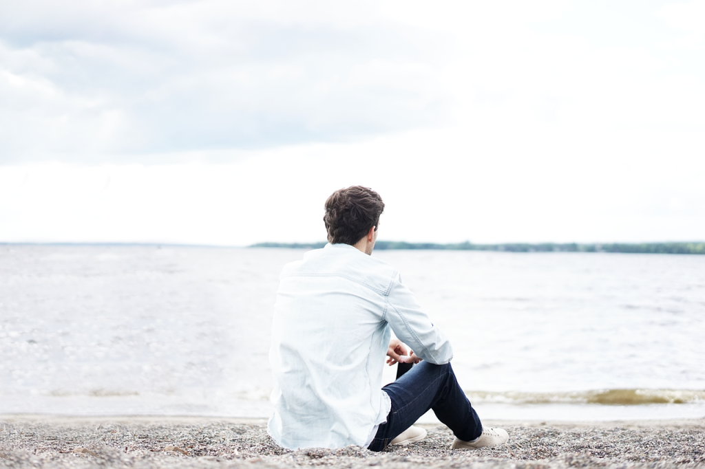 Homme de dos seul sur la plage
